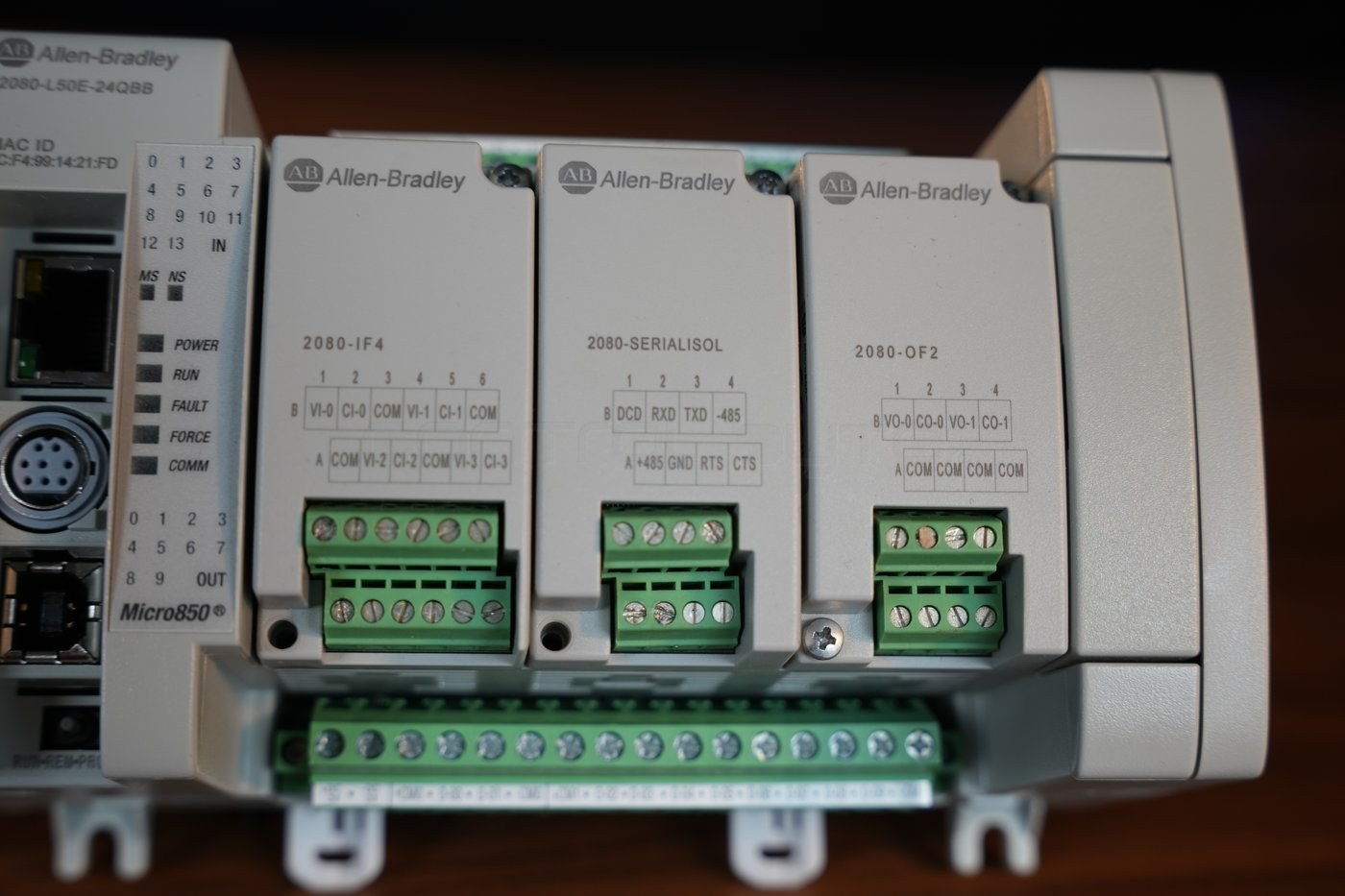 Three Micro850 plug-in modules - 2080-IF4, 2080-SERIALISOL and 2080-OF2 with terminal legends